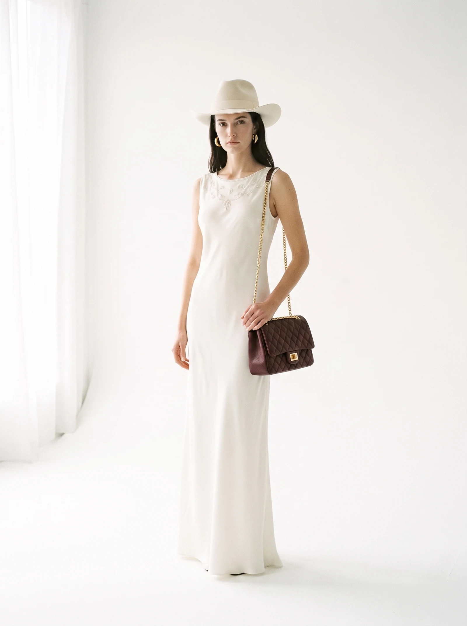 The dress, the hat, the earrings and the bag arrive as four separate packshots that were never in the same room. They come back as one look, on one model, in one frame.